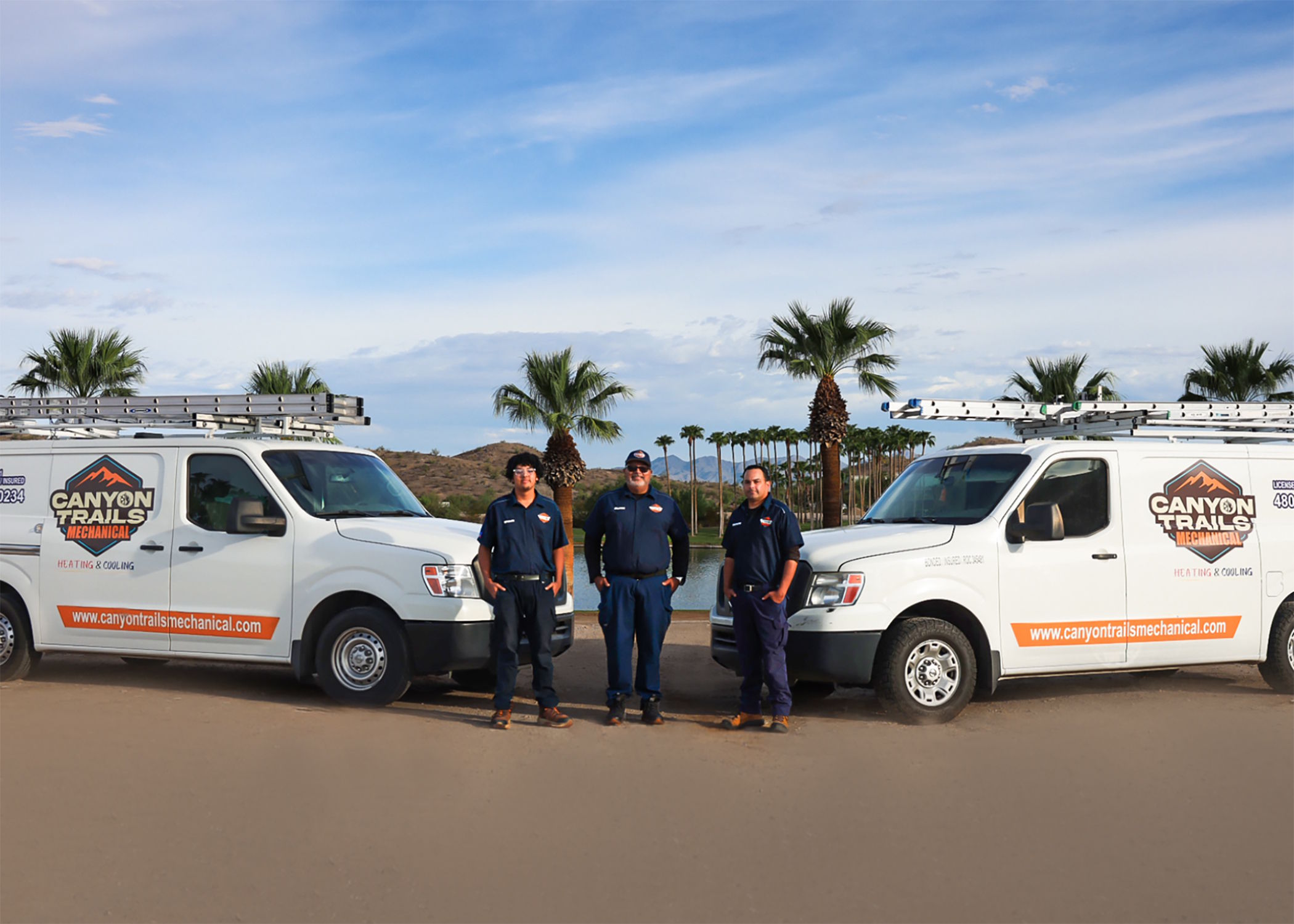 The Canyon Trails Mechanical team standing between two service vans
